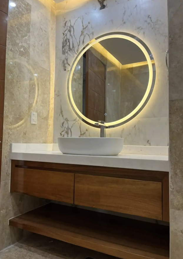 Round sink with backlit mirror in modern bathroom of the Isla Mujeres apartment