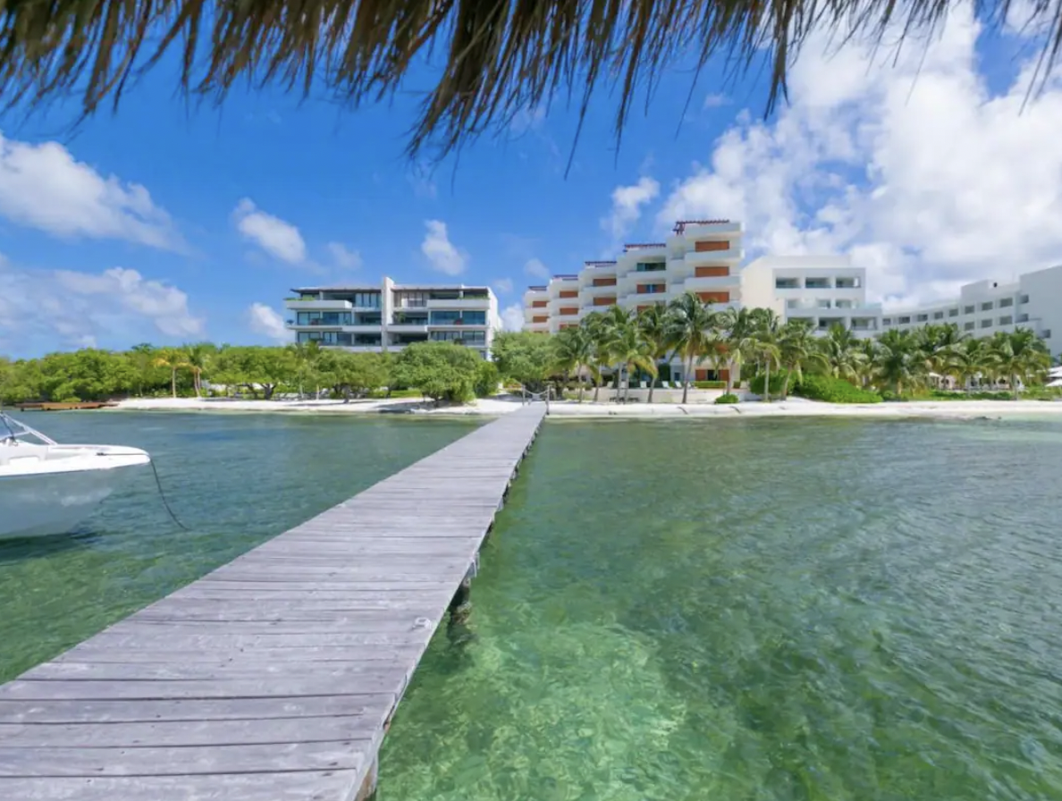 Wooden pier of Condominio Puerta al Mar looking out onto turquoise waters