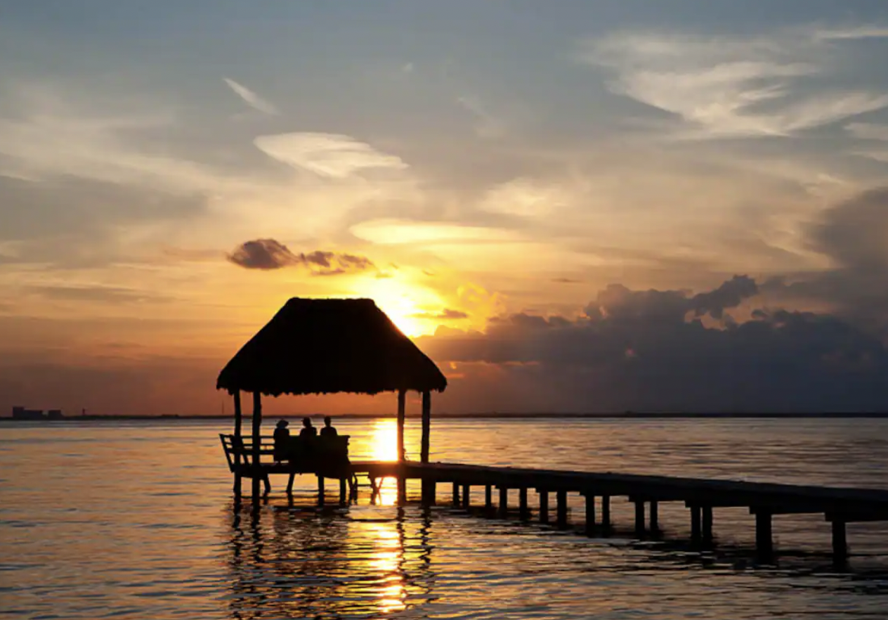 Golden sunset from palapa over the pier in Isla Mujeres
