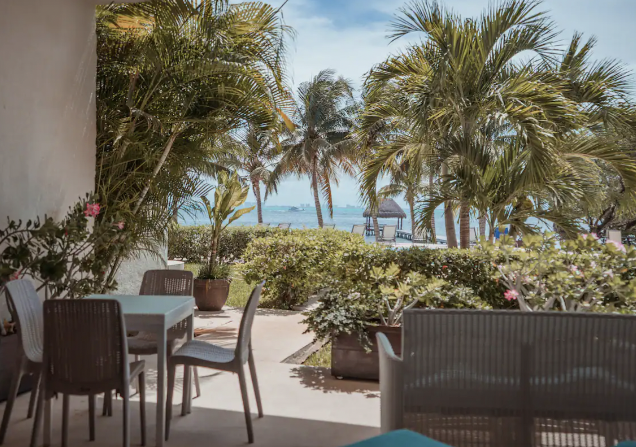 Apartment terrace with Caribbean Sea view through the palms in Isla Mujeres