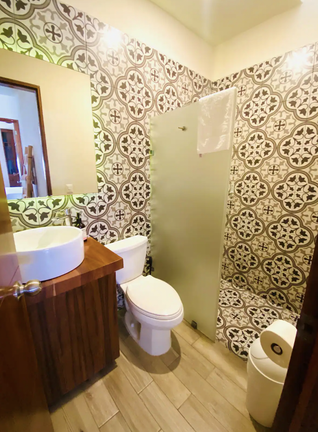 Bathroom with wood vanity, vessel sink and talavera mosaic