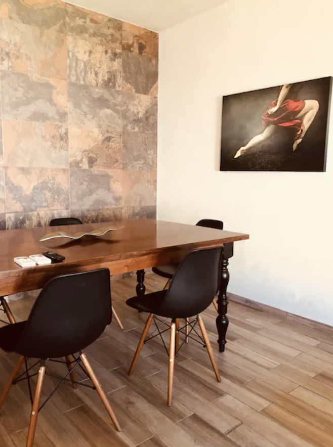 Wooden dining table with Eames chairs and decorative art