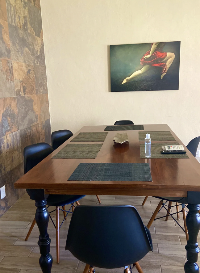 Wooden dining table for 6 with decorative art at Villa La Ceiba, Playa del Carmen